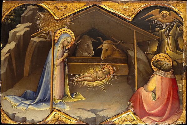 Mary adores the newborn Christ child in the stable at Bethlehem.